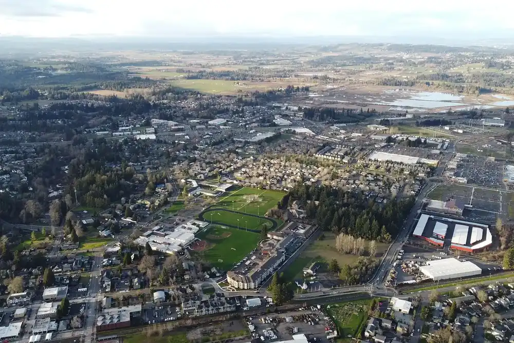 Aerial view of Sherwood, Oregon, with neighborhoods, sports fields and farmland beyond